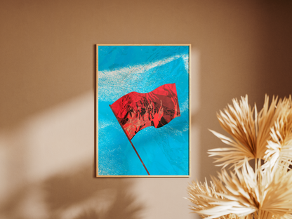Poster Drapeau Rouge - affiche accrochée sur un mur taupe à côté de feuilles séchées - Corentin GMT